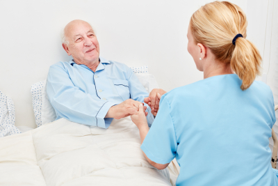 nurse holding the hands of a senior patient