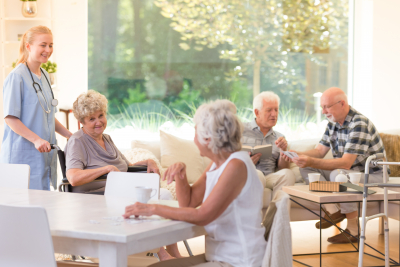 group of seniors spending free time in bright living room