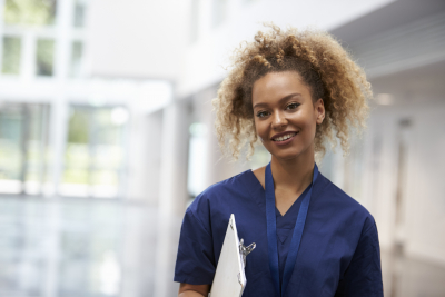 portrait Of female nurse wearing scrubs in hall